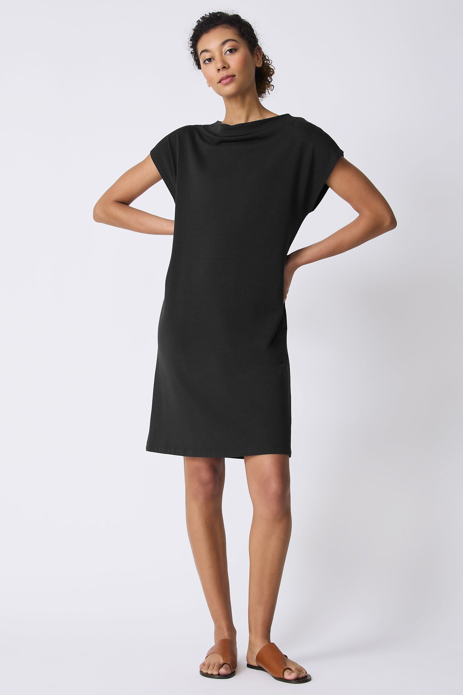 Kal Rieman Luca Cowl Dress in Black on model with hands on hips full front view