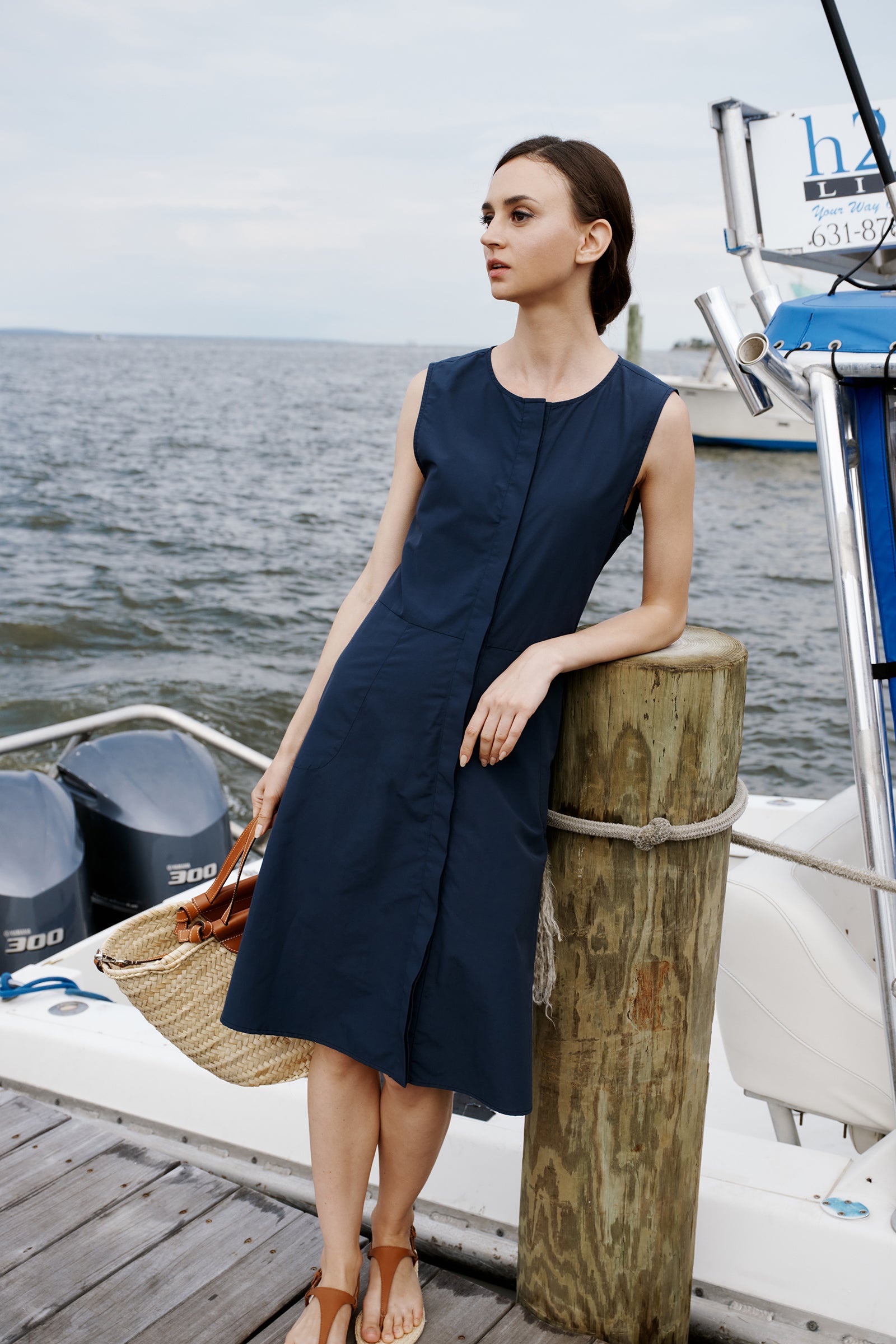 Kal Rieman Marina Dress in Summer Navy on model with hands in pockets full front view