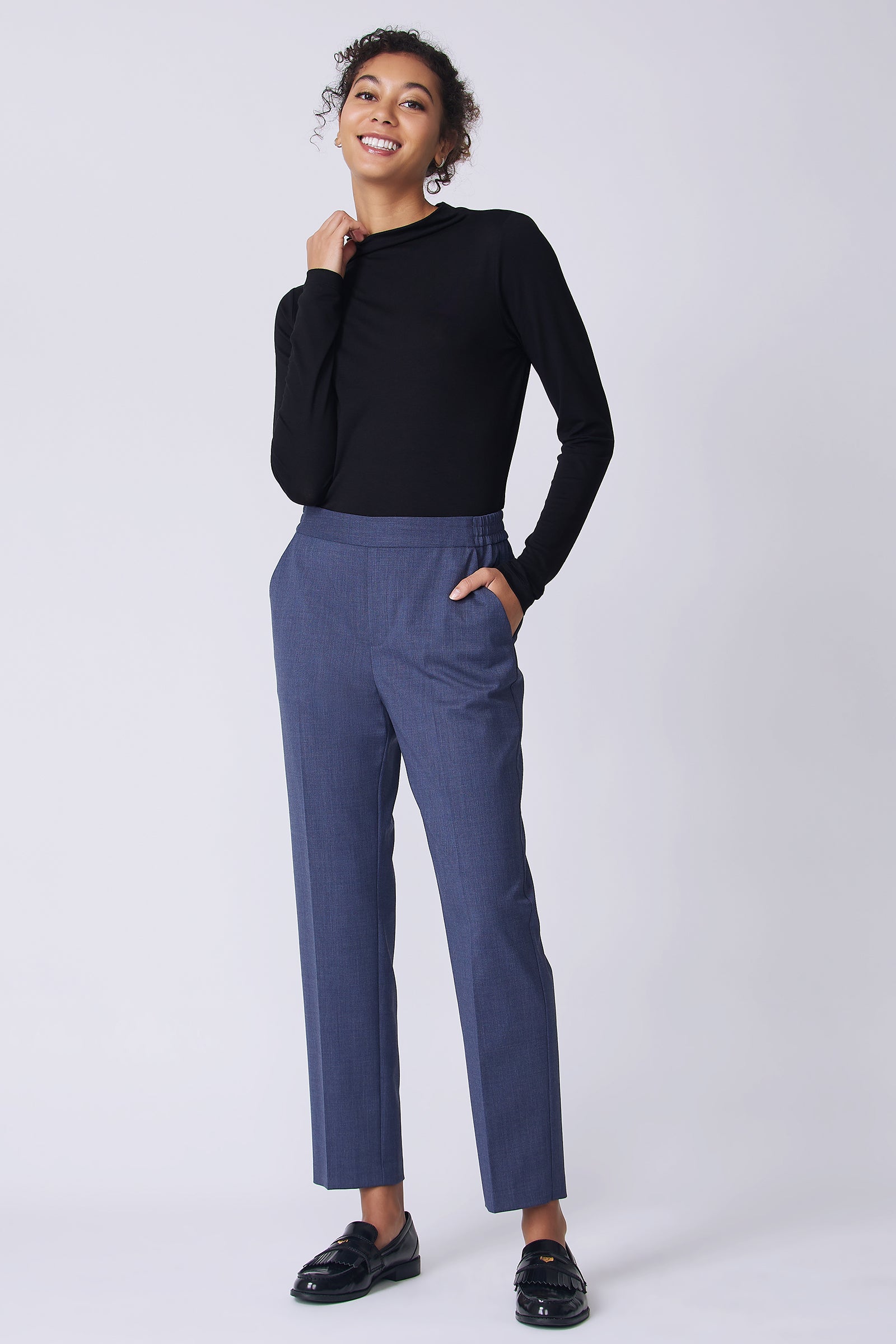 Kal Rieman Martine Trouser in Italian denim suiting on model front view hand in pocket holding collar