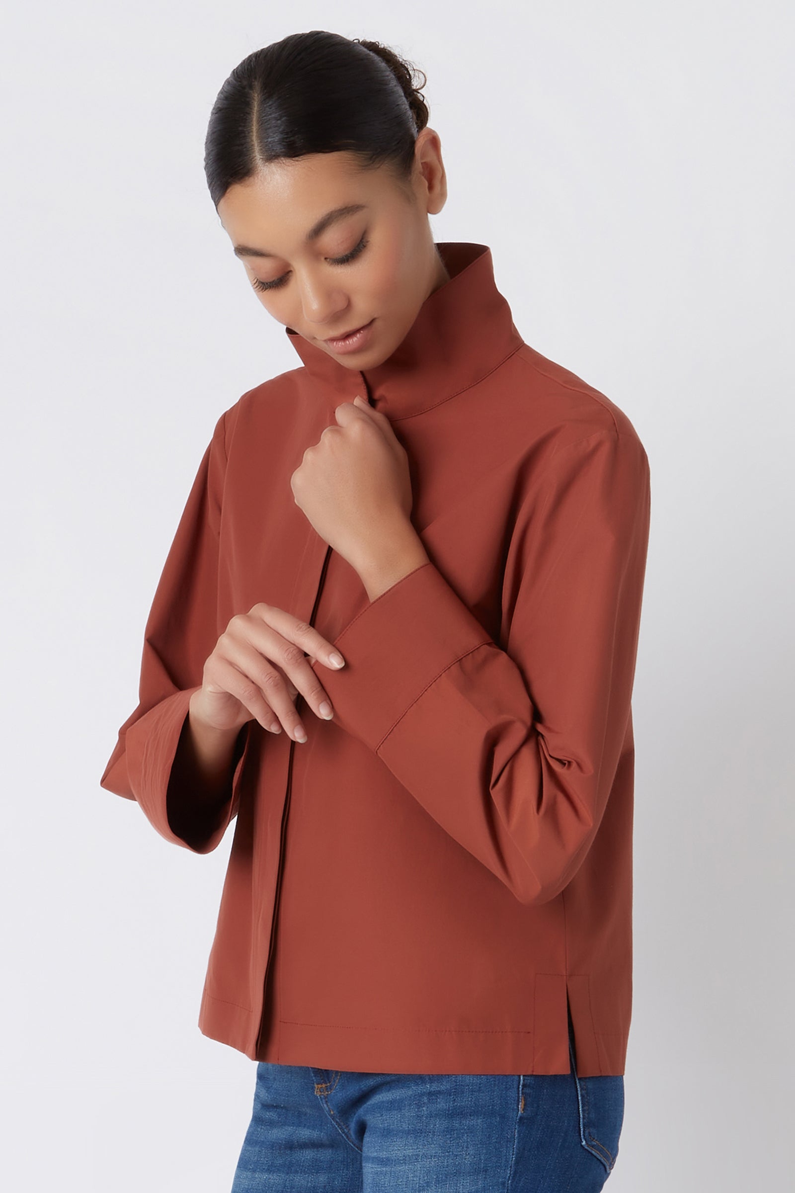 Kal Rieman Peggy Collared Shirt in Rust Broadcloth on Model Touching Cuff Cropped Front View
