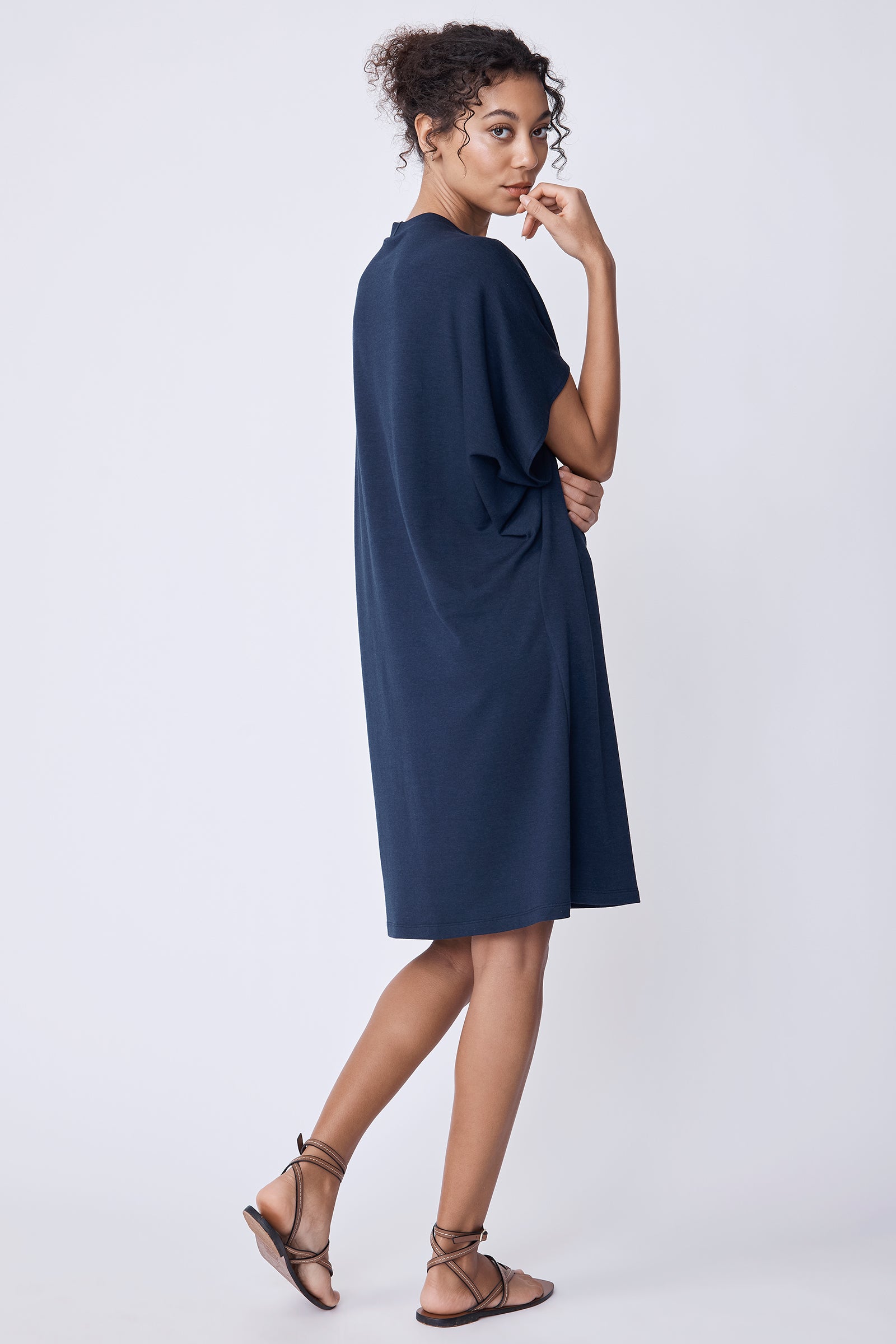 Kal Rieman Phoenix Cape Dress in navy on model with arms crossed full front view