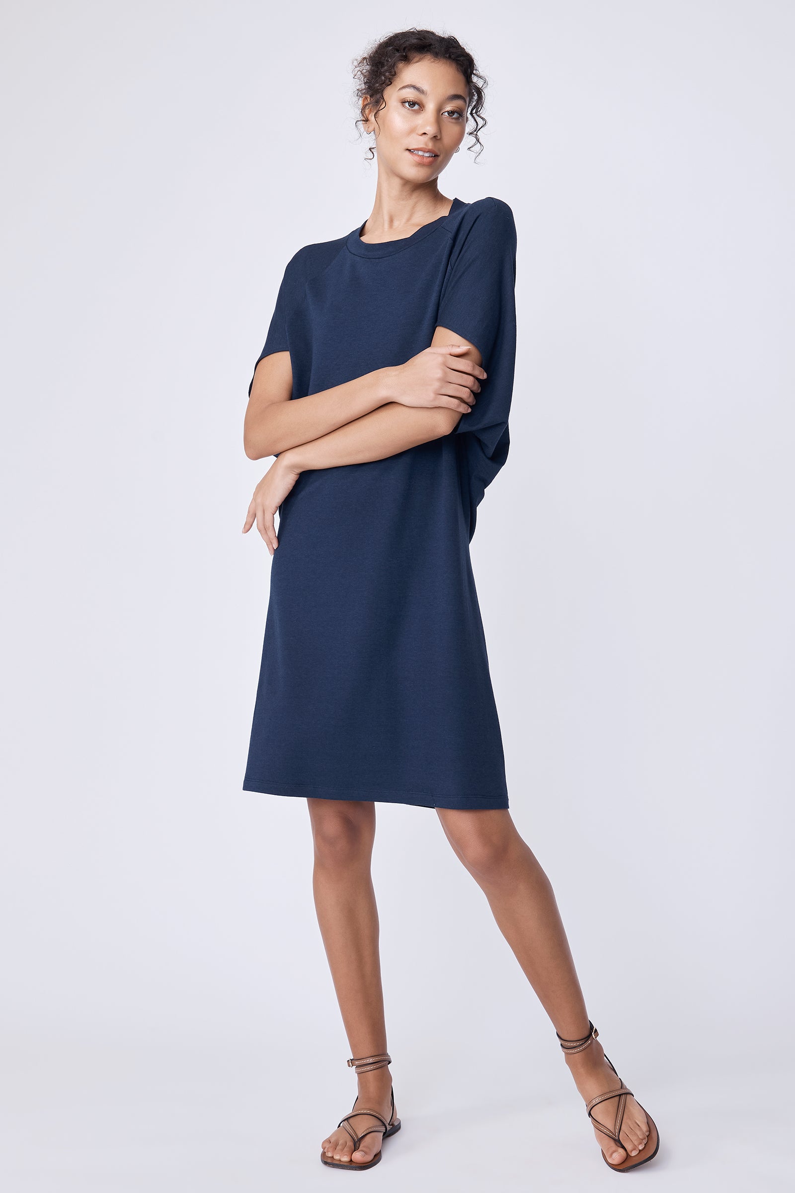 Kal Rieman Phoenix Cape Dress in navy on model with arms crossed full front view