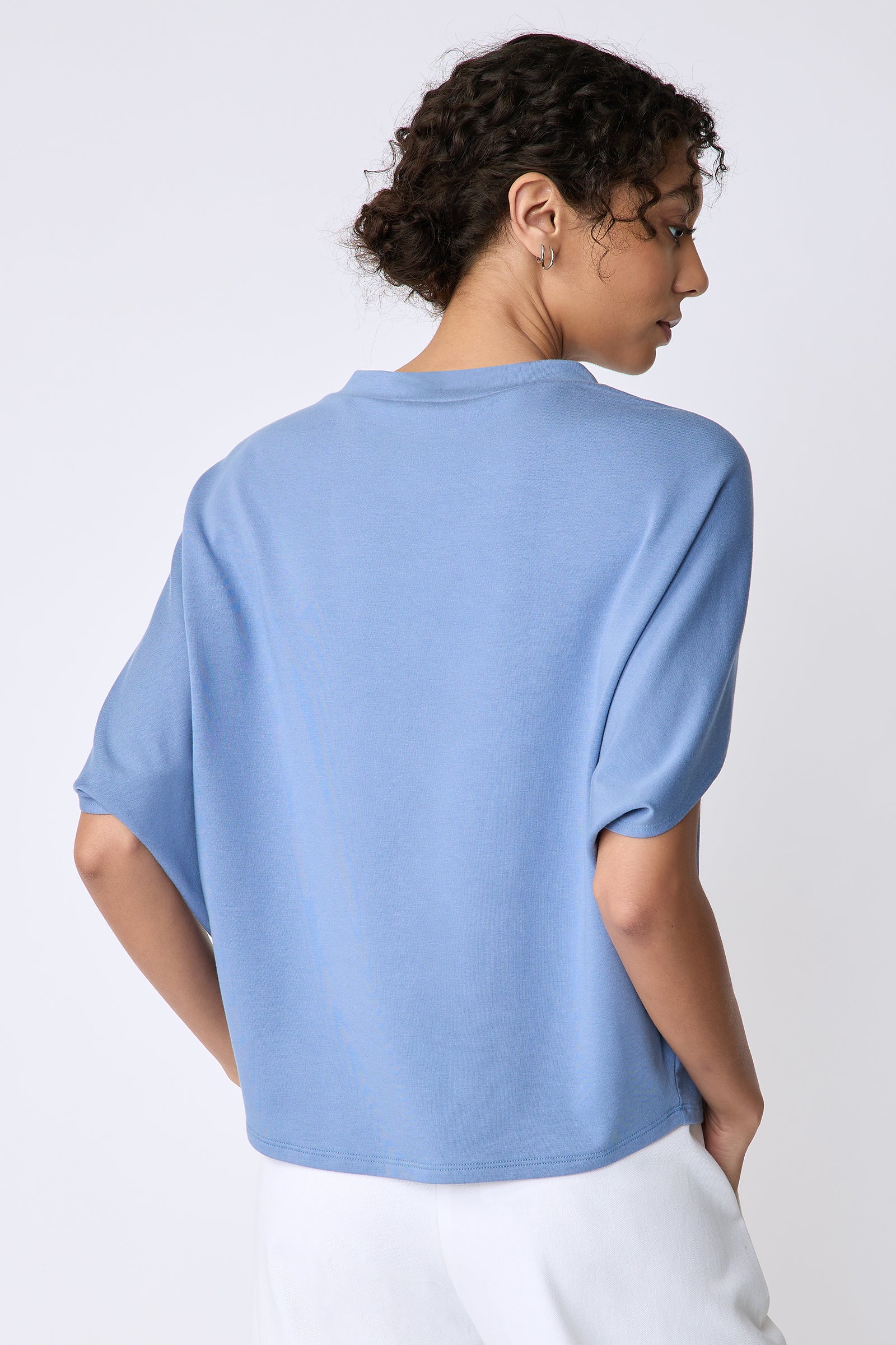 Kal Rieman Phoenix Cape Top in sky blue on model front view arms crossed