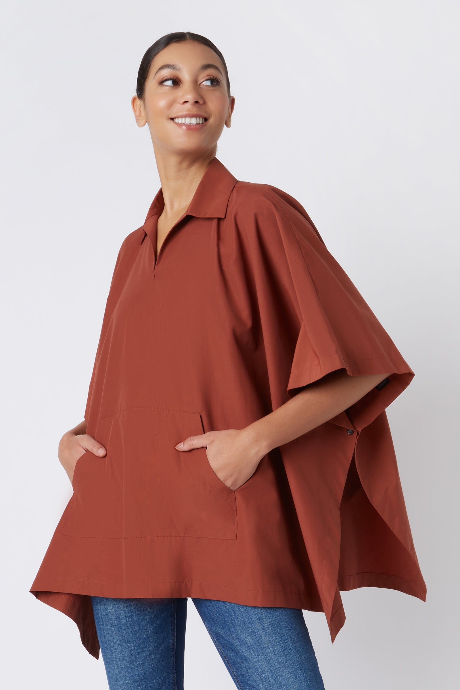 Kal Rieman Pocket Poncho in Rust Italian Broadcloth on Model with Hands in Pockets Cropped Front View