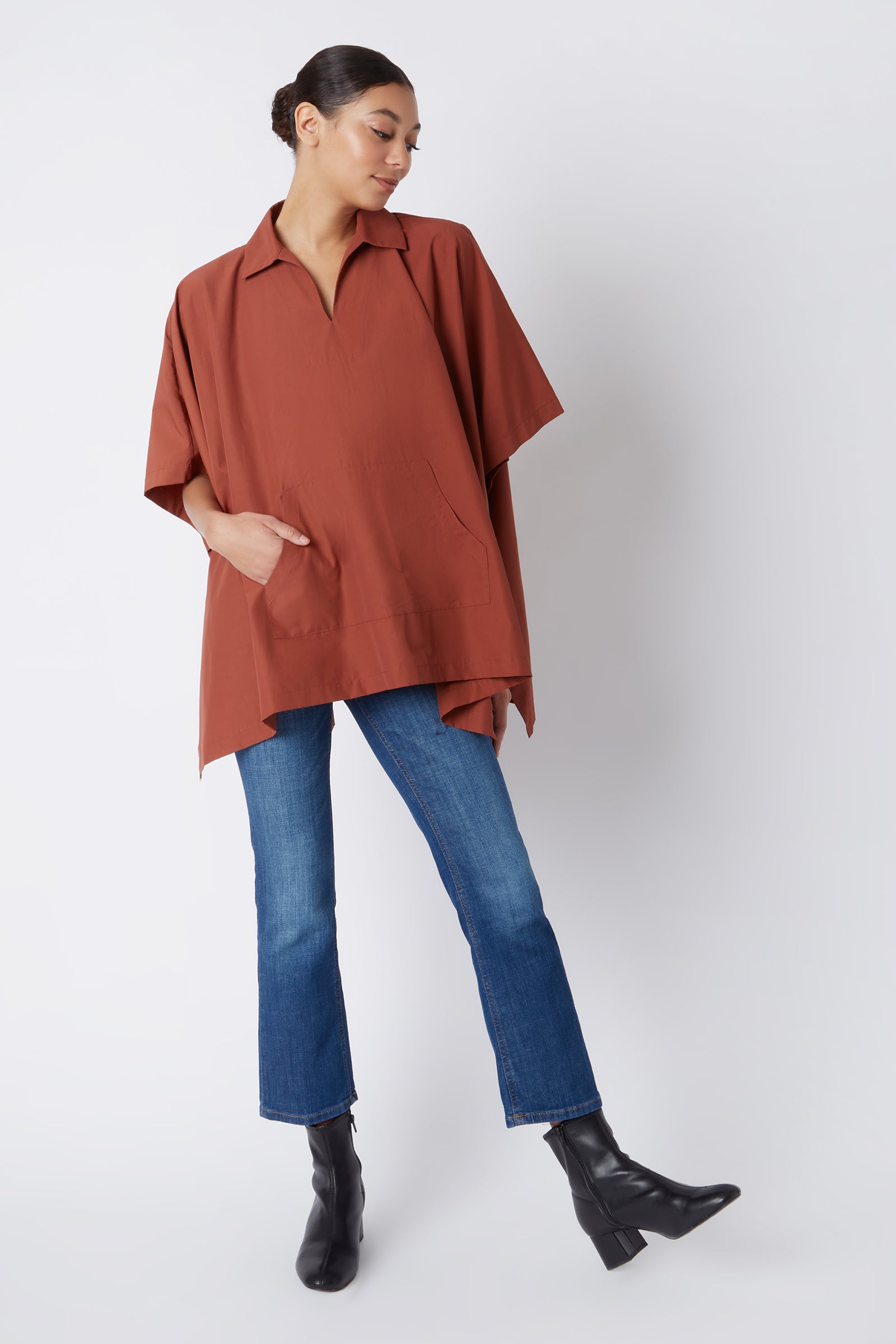 Kal Rieman Pocket Poncho in Rust Italian Broadcloth on Model Looking Down with Hand in Pocket Full Front View