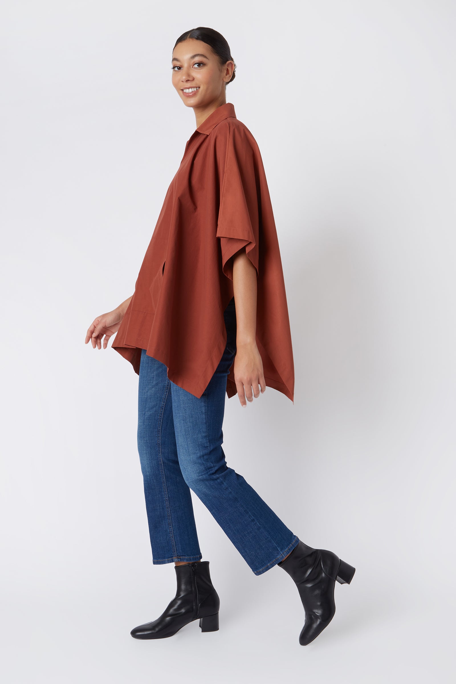 Kal Rieman Pocket Poncho in Rust Italian Broadcloth on Model Walking Full Side View