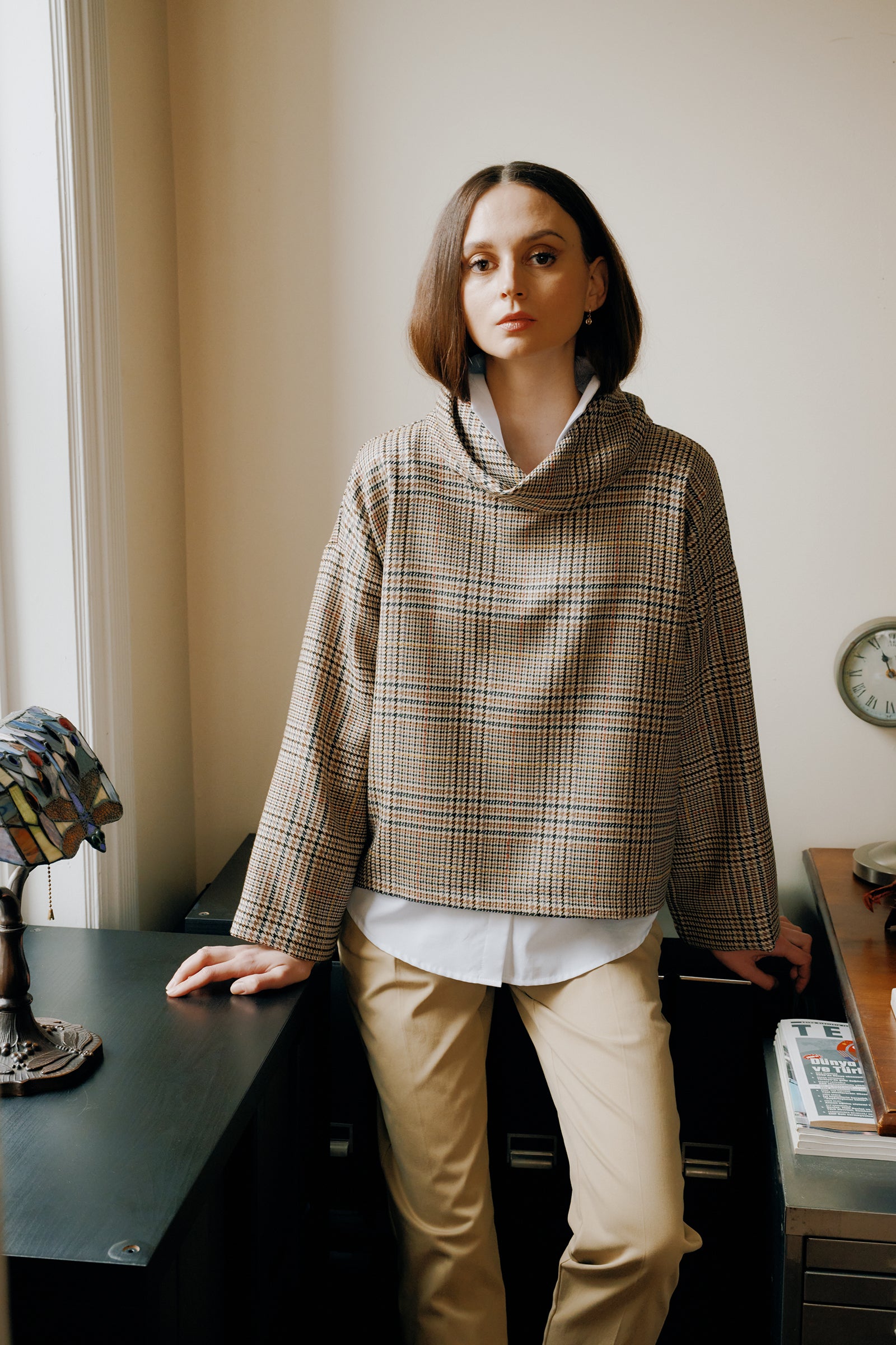 Kal Rieman Polina Bias Tneck Pullover in italian plaid on model side view holding collar walking