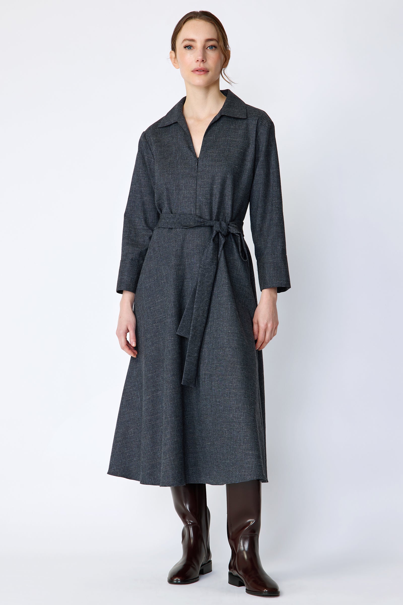 Woman wearing Kal Rieman Sydney Dress in Indigo Denim Wool with brown boots, arms on the side, full front view