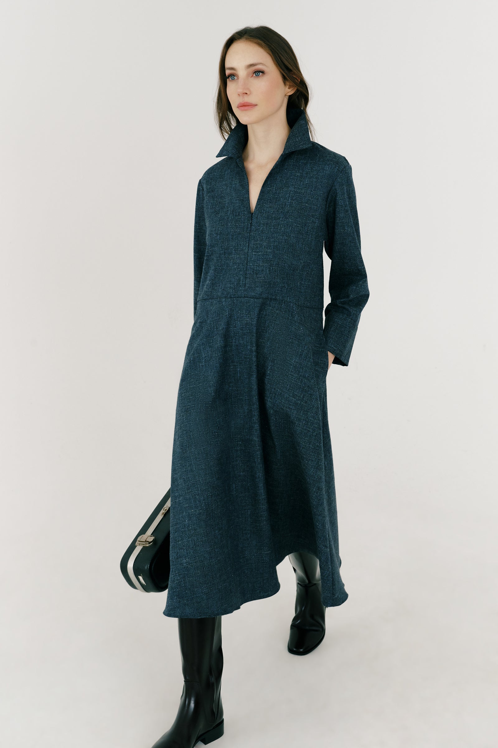 Woman wearing Kal Rieman Sydney Dress in Indigo Denim Wool with brown boots, arms on the side, full front view