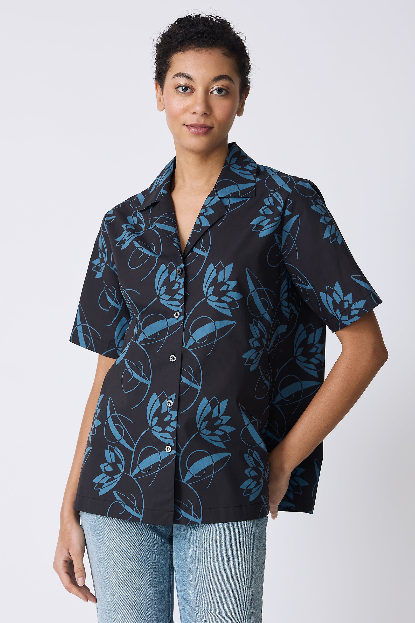 Kal Rieman Vacation Shirt in Lotus Print Blue on model with hand on hip front view
