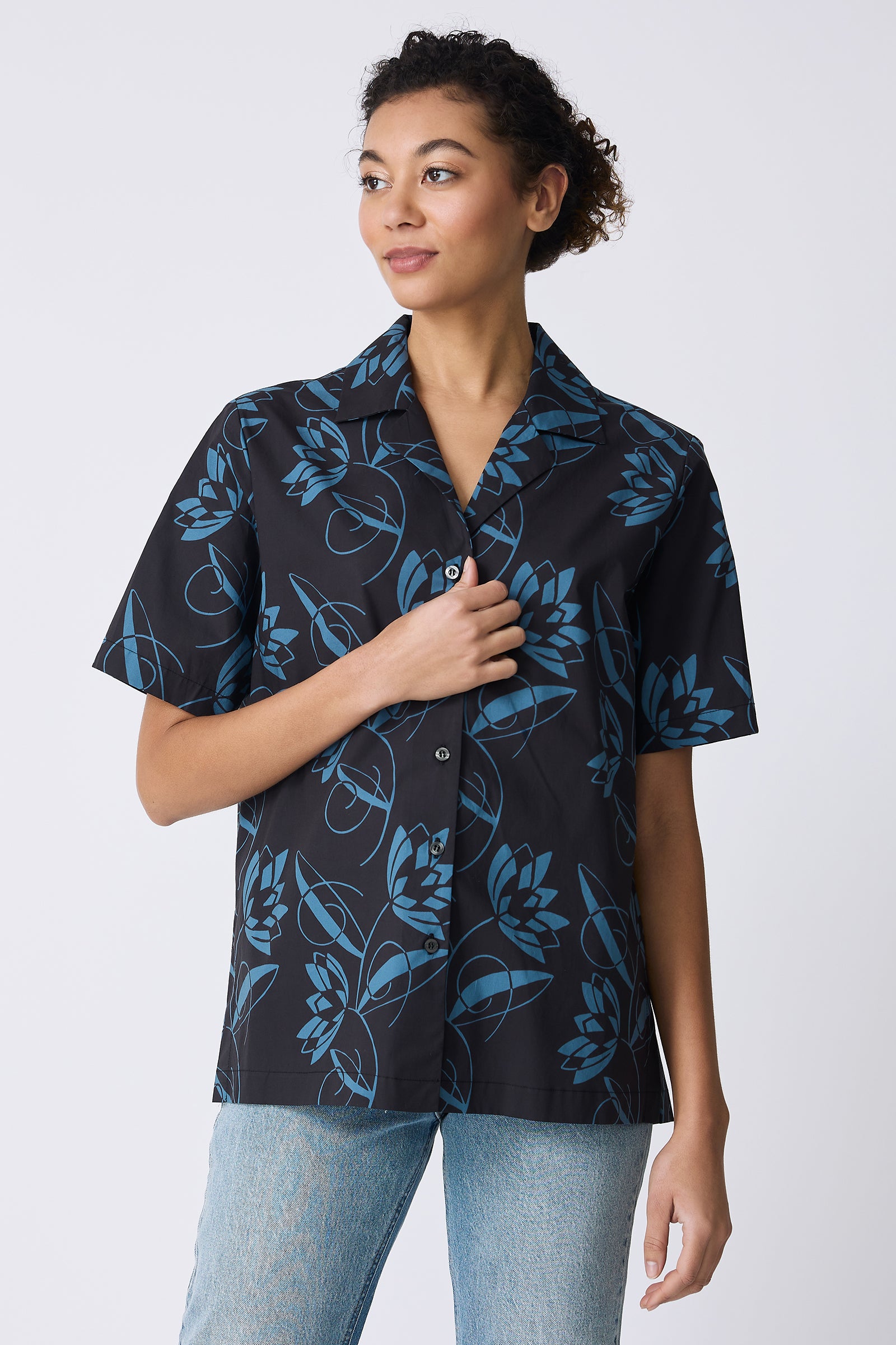 Kal Rieman Vacation Shirt in Lotus Print Blue on model touching shirt front view