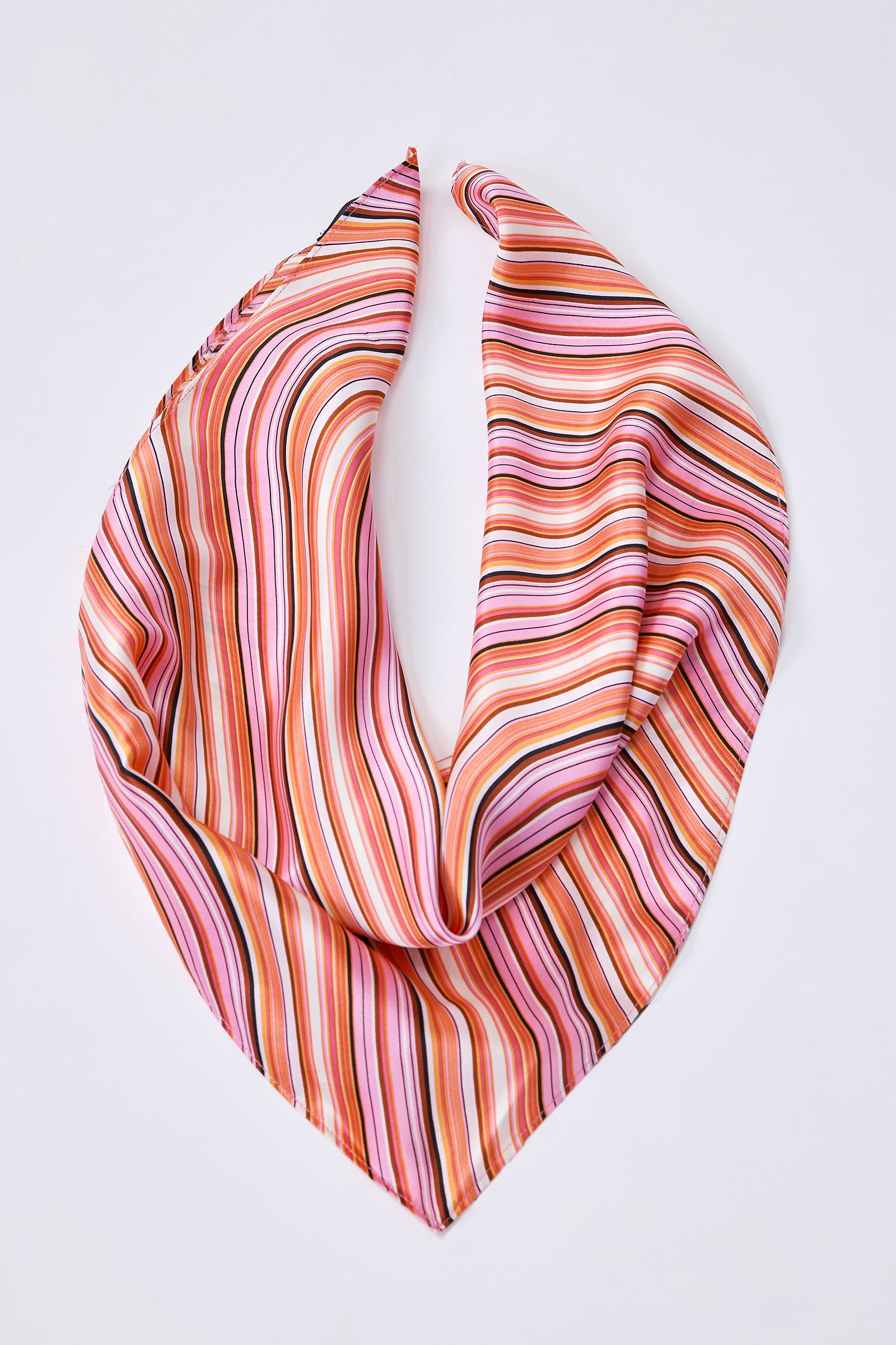 Kal Rieman Scarf in Capri Silk on model holding scarf wearing a navy blazer front view