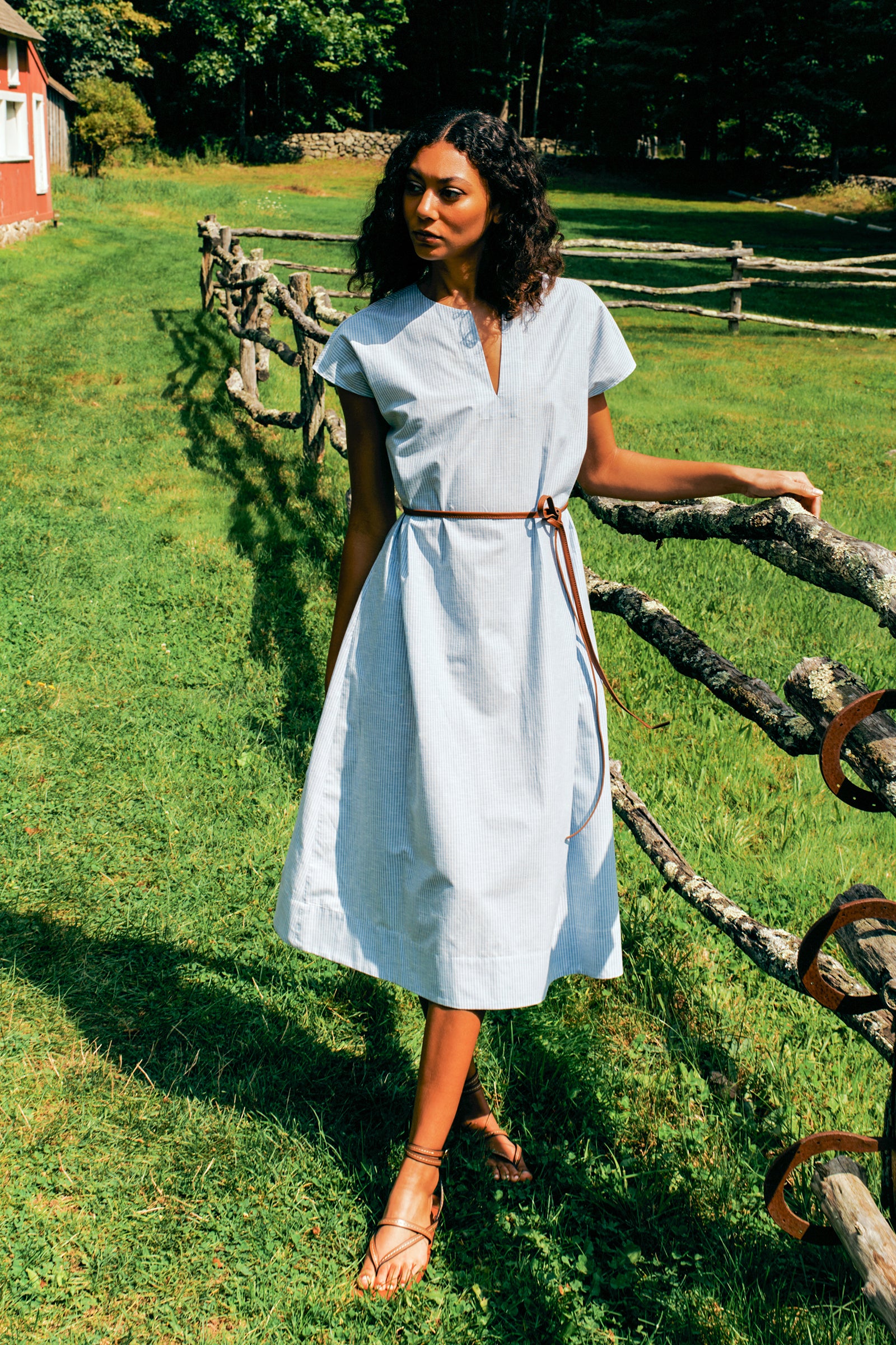 Kal Rieman Clara Dress in light blue mini stripe on model front view hands behind back