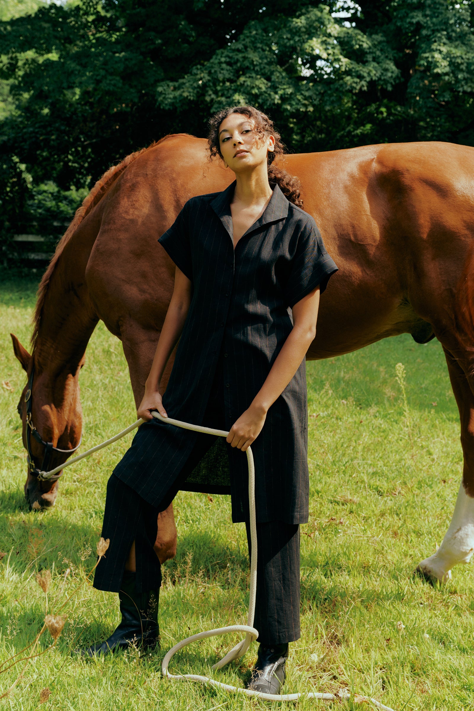 Kal Rieman Holly Kimono Dress in black pinstripe linen on model front view hand behind back