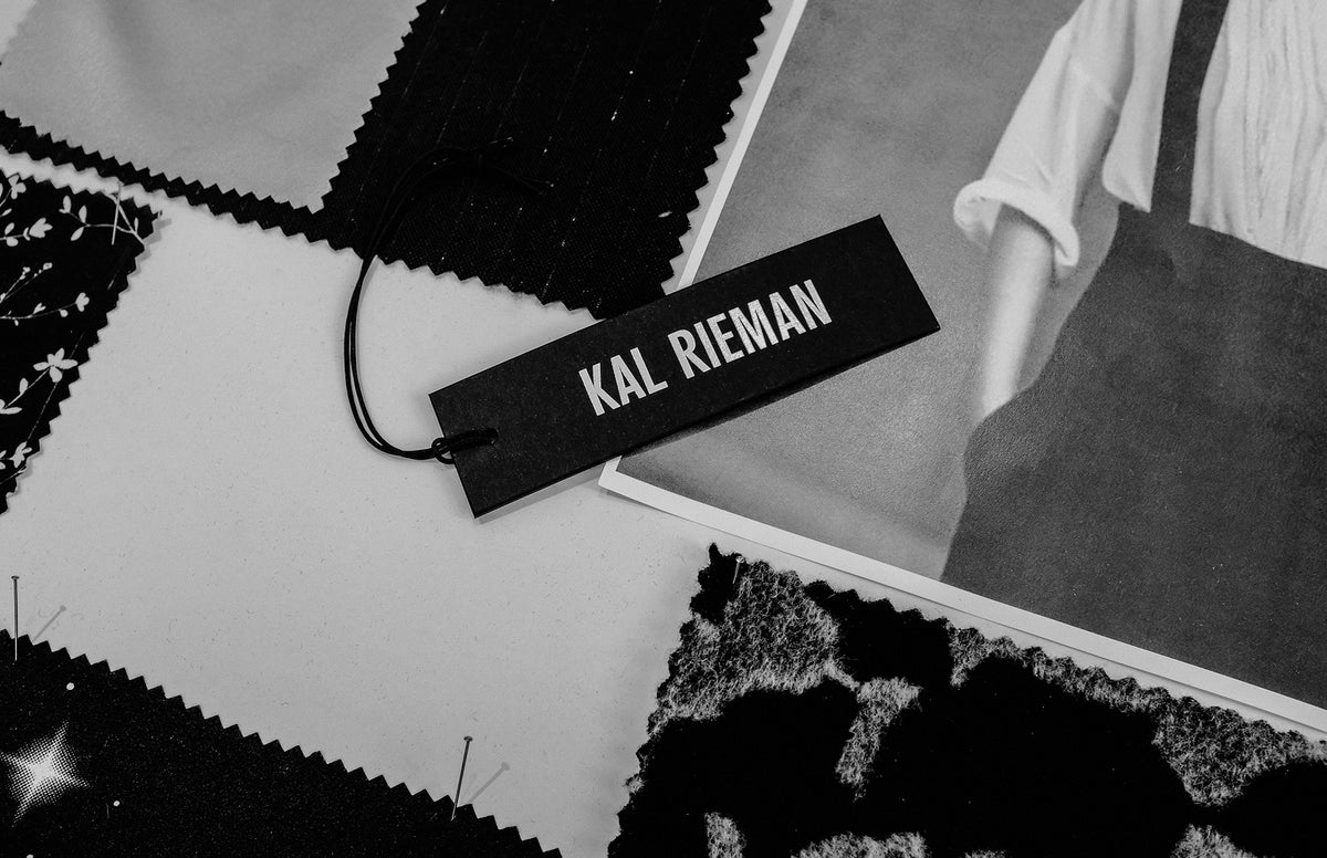 Kal Rieman image of apparel tag in black and white sitting on fabric swatches