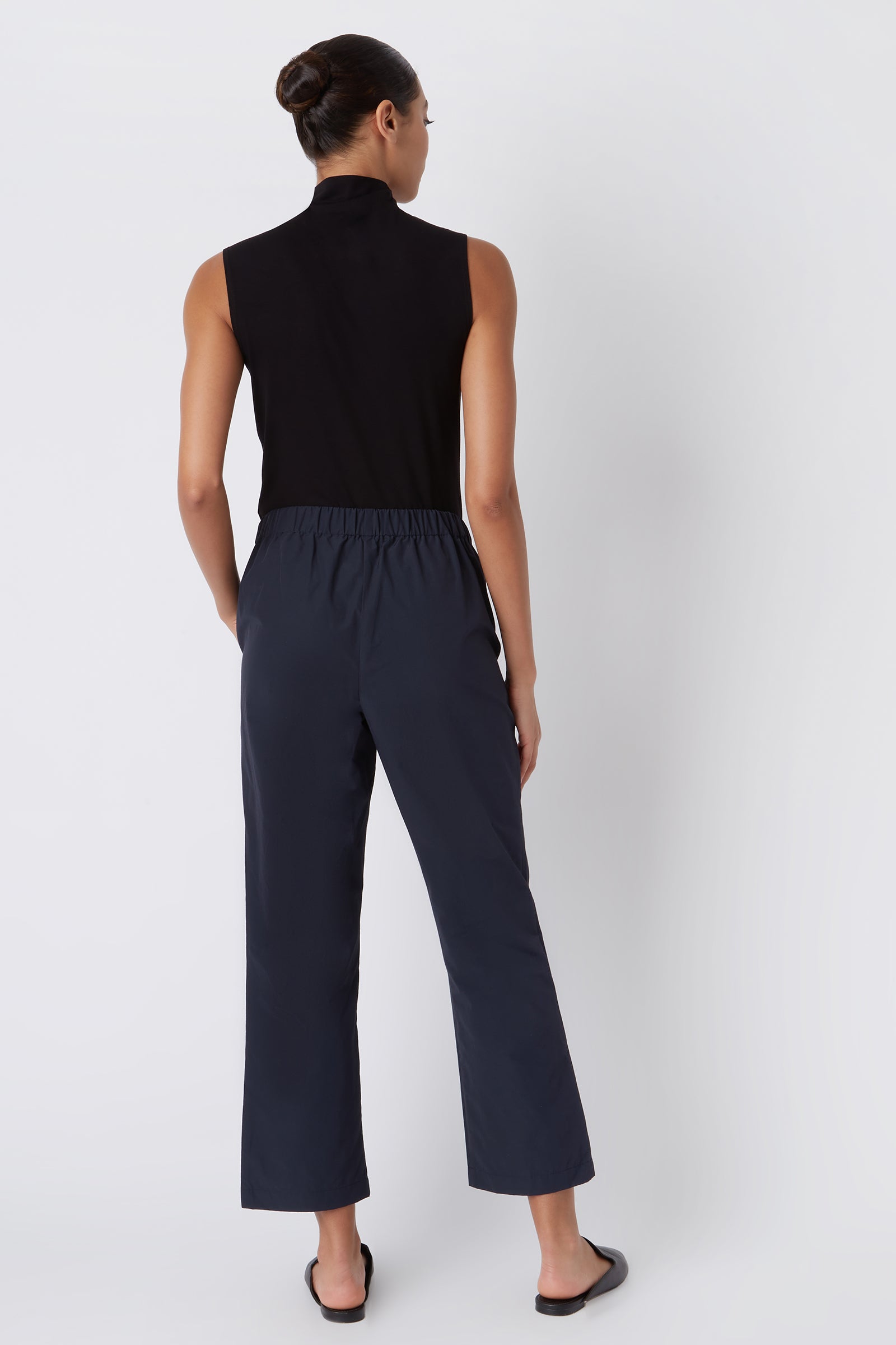 Kal Rieman Brit Crop Pant in Navy on Model with Hands in Pockets Full Front View