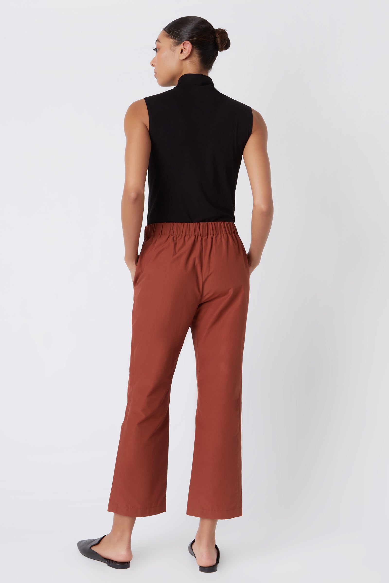 Kal Rieman Brit Crop Pant in Rust Italian Broadcloth on Model with Hands in Pocket Full Front View