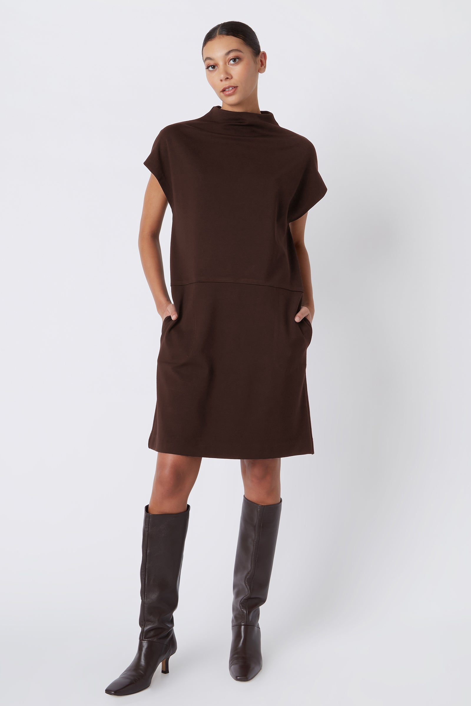 Kal Rieman Maya Funnelneck Dress in Espresso Ponte on model with hands in pockets full front view