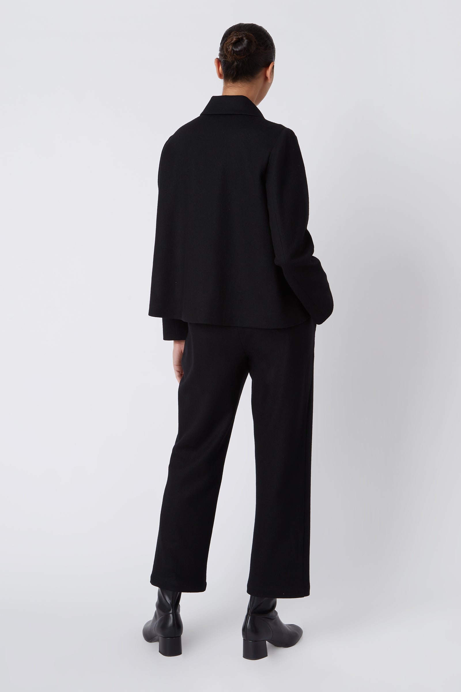 Kal Rieman Sylvie FJ Swing Jacket in Black Felted Jersey on Model with Hands in Pockets Cropped Front View