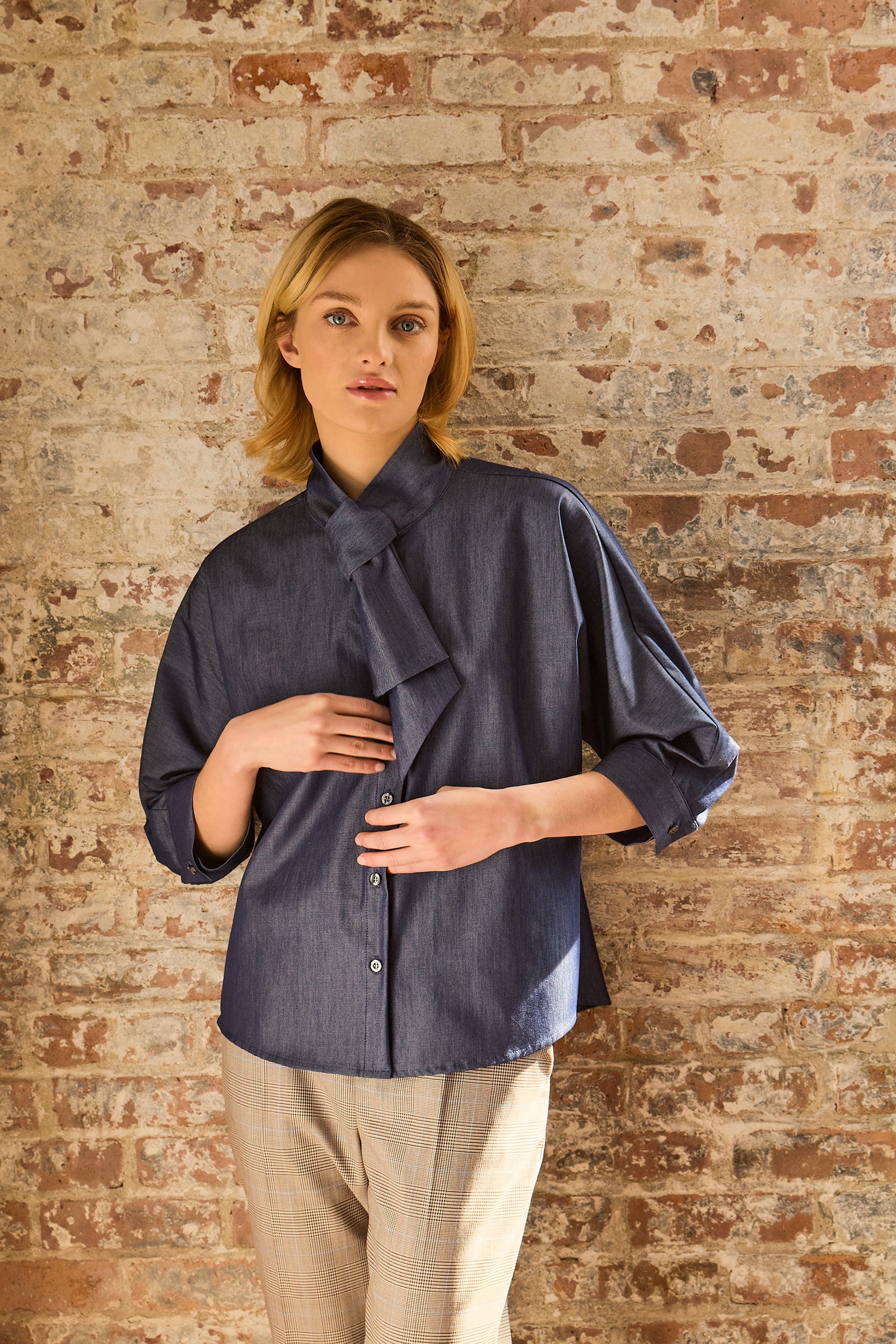 Kal Rieman Vanessa Bow Blouse in Denim on model with hands in pocket front view