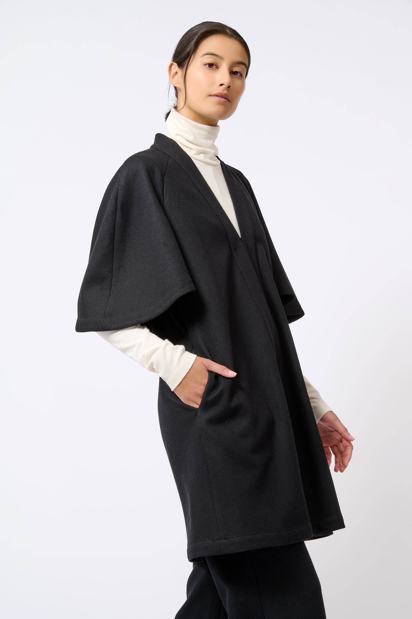 Kal Rieman Cape Back Cardigan in Black on Model with Hand in Pocket  Front View