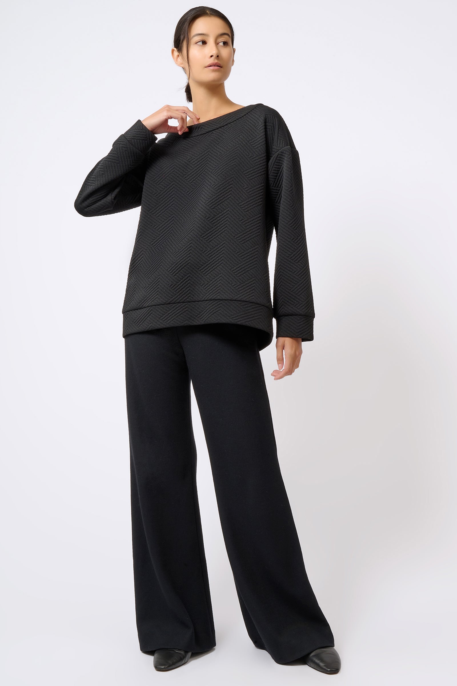 Kal Rieman Carmen Banded Sweatshirt in Black Escher Knit on Model with Hand on Collar Full Front View