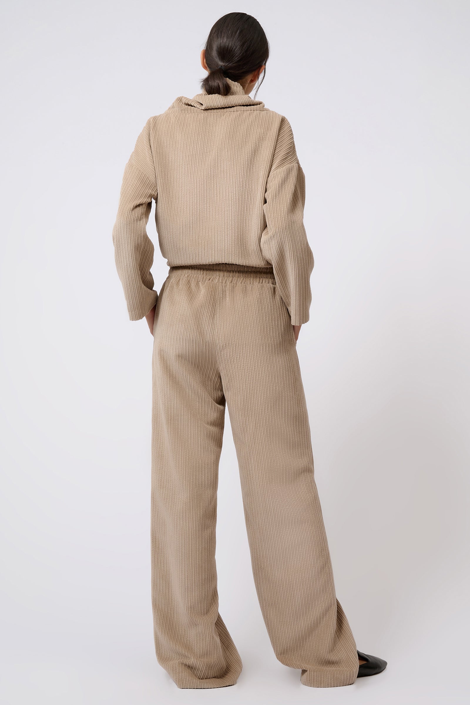 Kal Rieman Debbie Drawstring Pant in Beige on Model with Hands in Pockets Full Back View