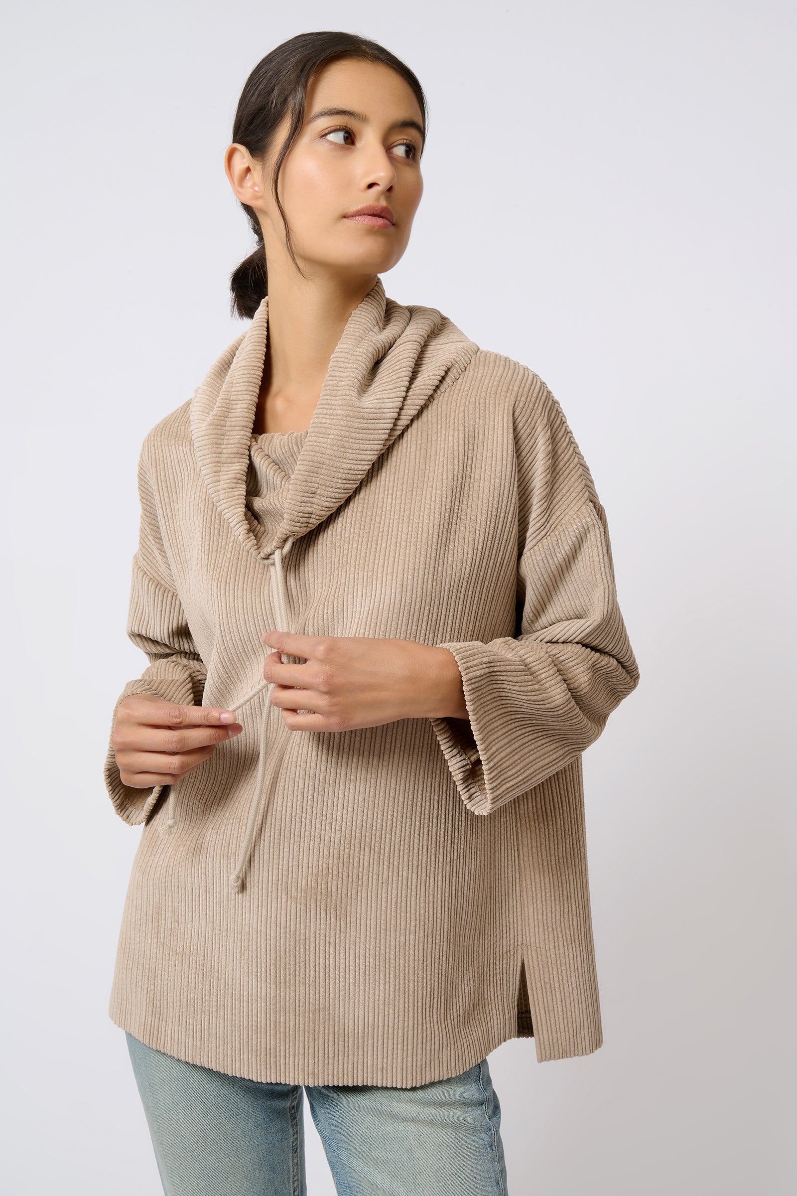 Kal Rieman Debbie Drawstring Pullover in Beige on Model with Hands on Strings Front View