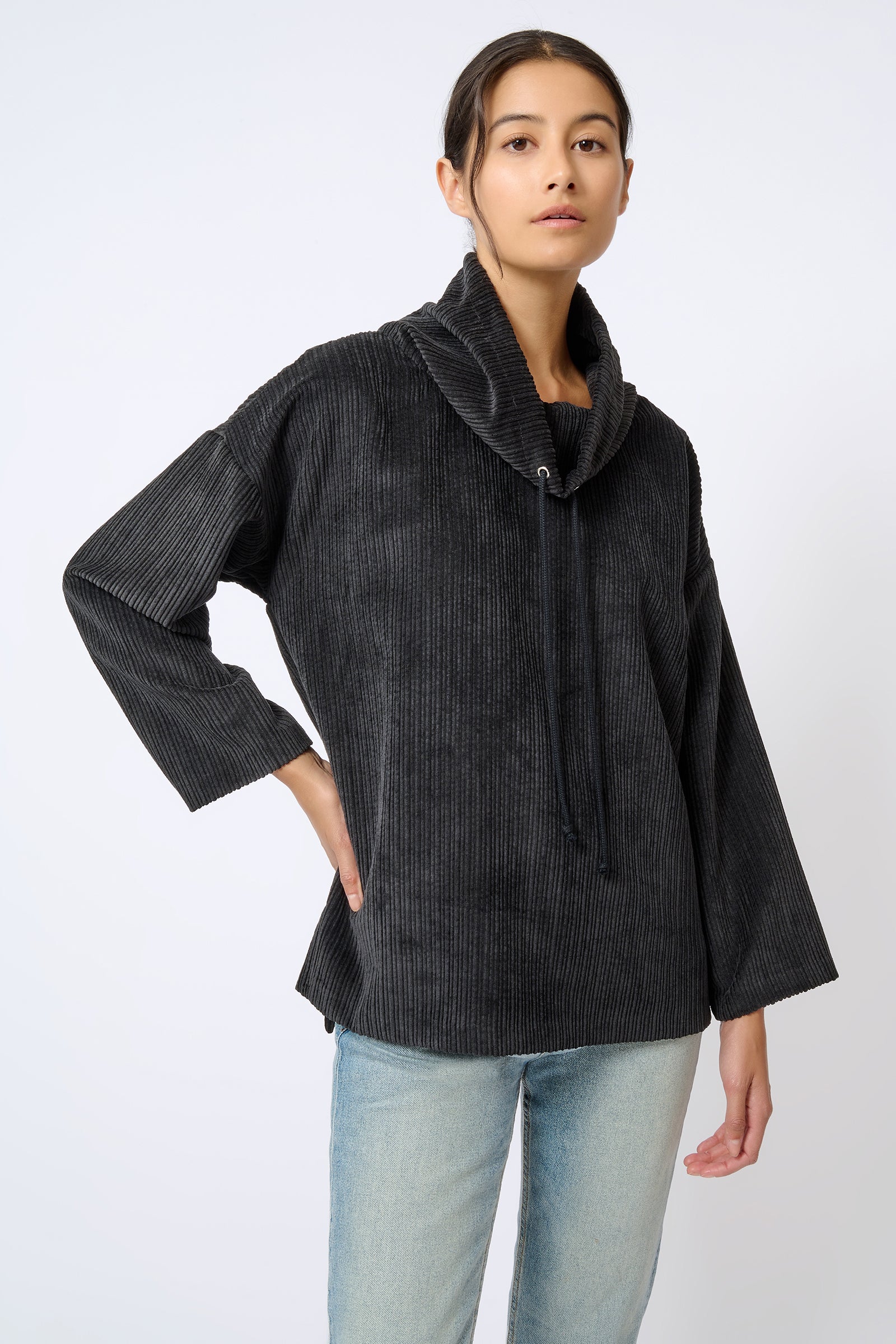 Kal Rieman Debbie Drawstring Pullover in Black on Model with Hand on Hip Looking Forward Front View