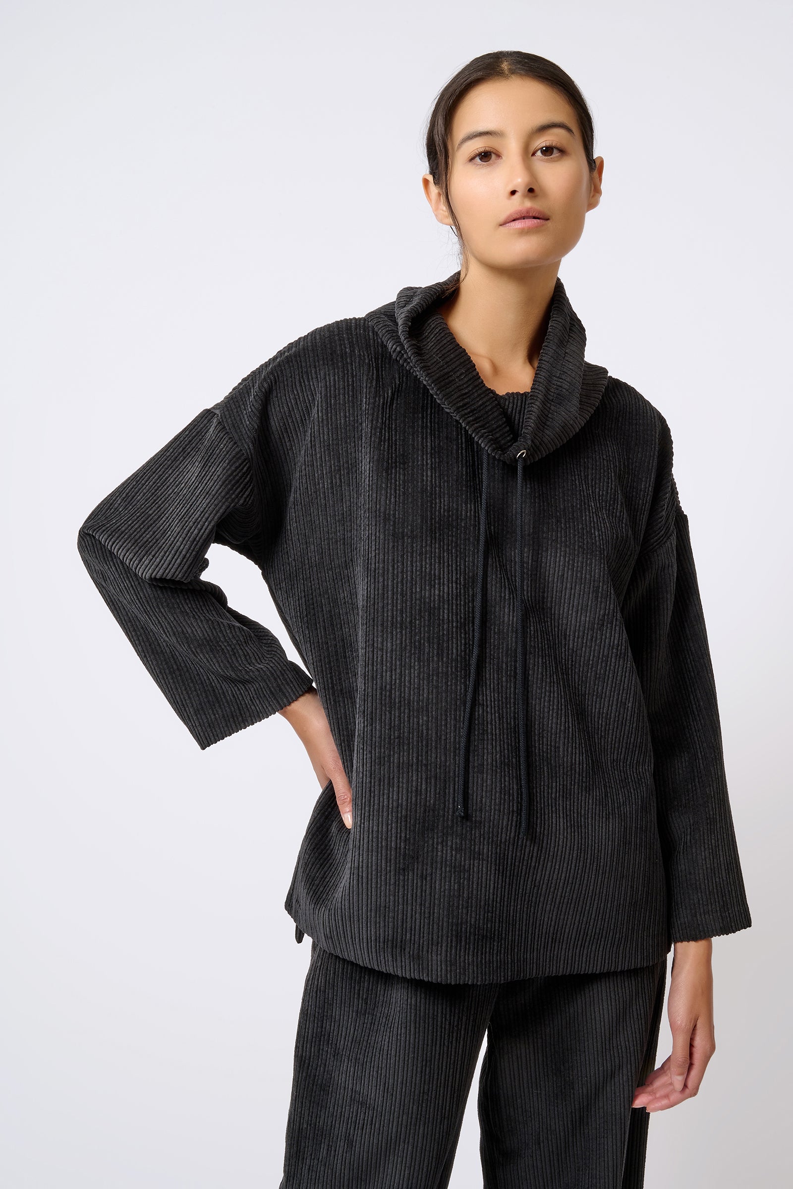 Kal Rieman Debbie Drawstring Pullover in Black on Model with Hand on Hip Front View