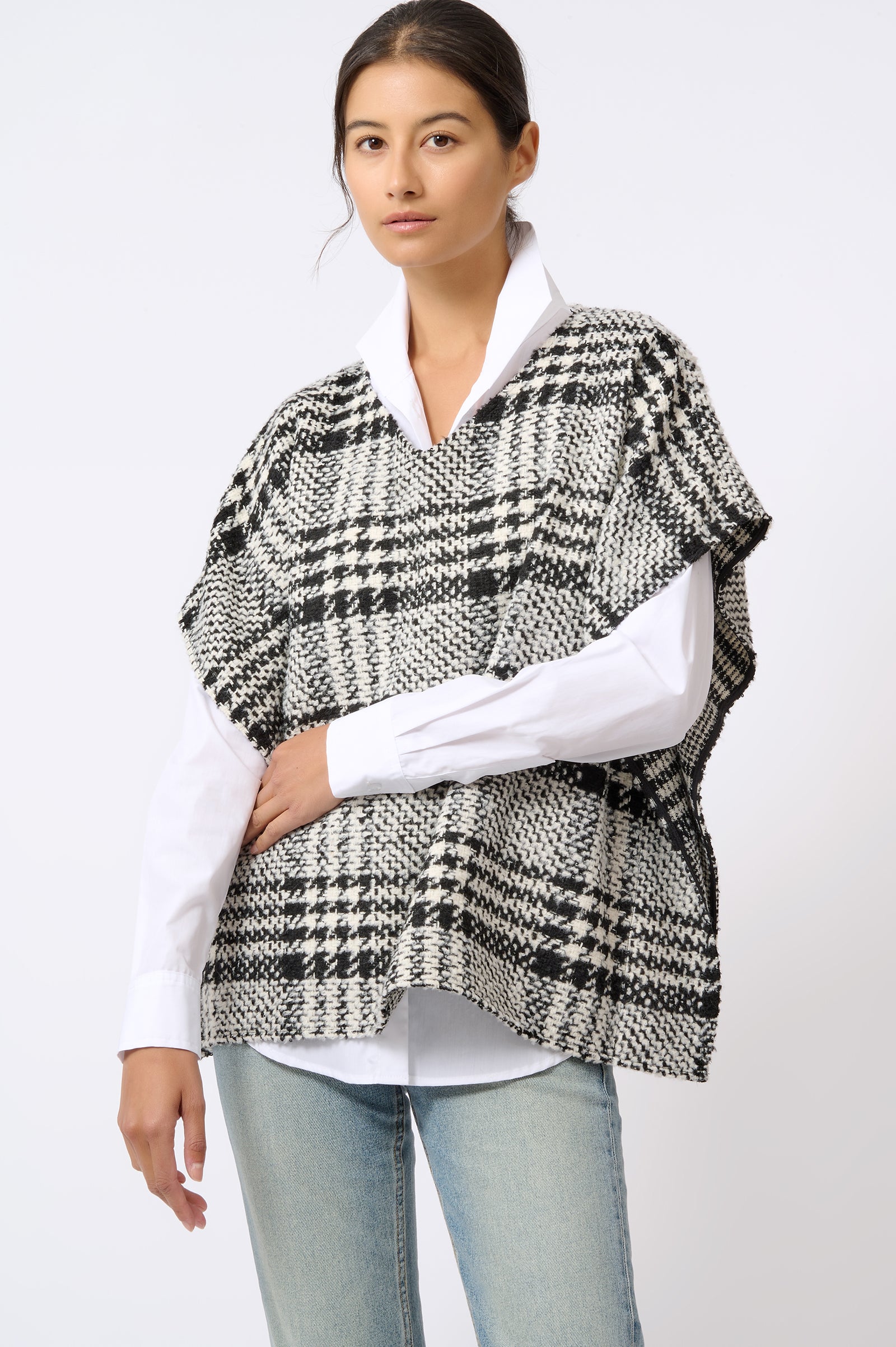 Kal Rieman Plaid Poncho in Black and White Plaid on Model with Arm Crossed Front View