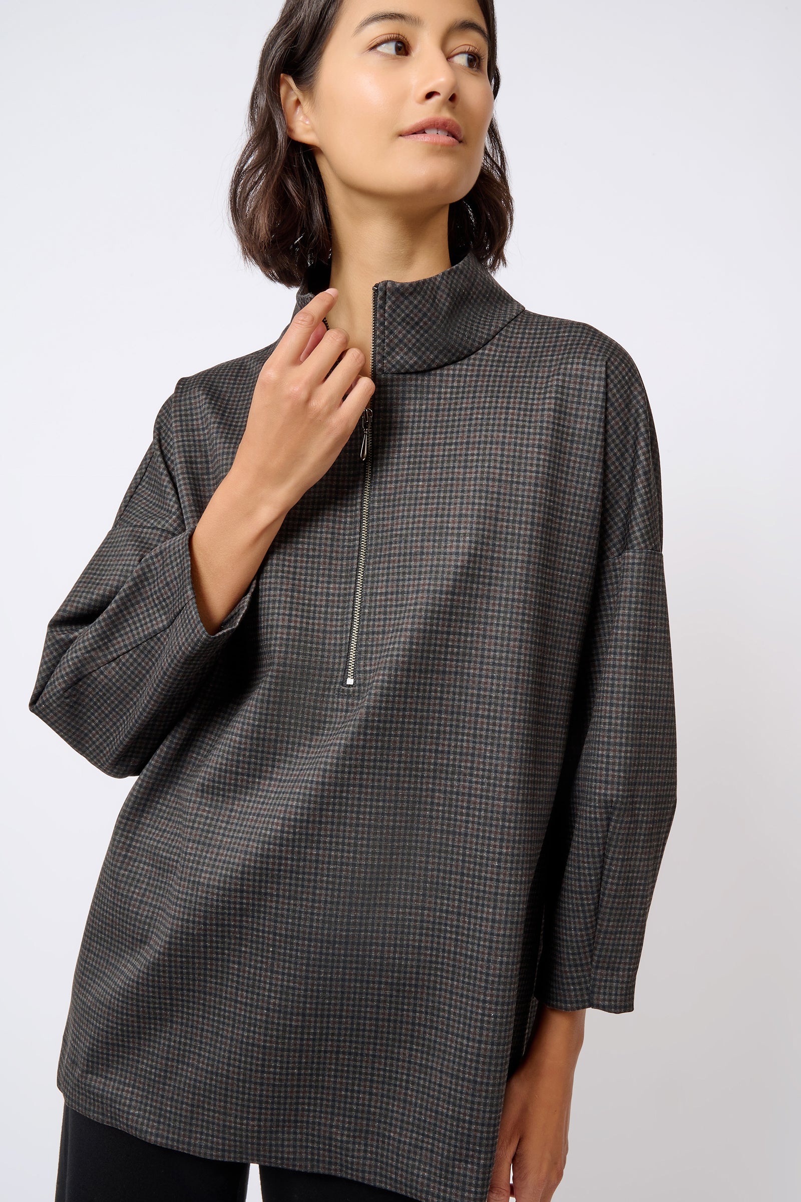 Kal Rieman Zip Mock Top in Mini Check Print on Model with Hand Up Front View